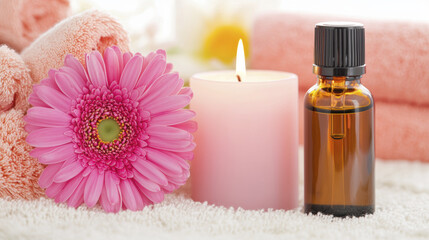 serene spa setting featuring pink flower, candle, and essential oil bottle, creating calming atmosphere for relaxation