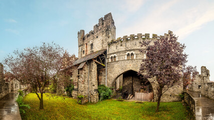 External view of the medieval stone walls of the Castle of the Counts (Gravensteen) in Ghent, Belgium
