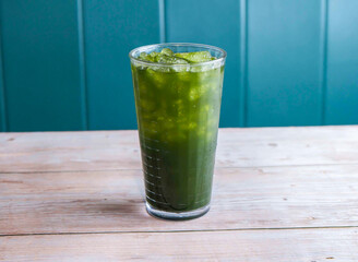Fresh Coconut with Centella Asiatica ice drink with iced cubes served in glass isolated on wooden background side view of Hong Kong drink