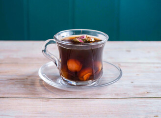 Longan Tea with Rose Petals served in cup isolated on wooden background side view of Hong Kong hot drink