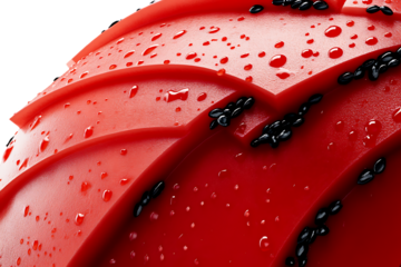 Close-up of Red Water-Repellent Surface with Black Micro-Particles
