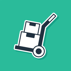Blue Hand truck and boxes icon isolated on green background. Dolly symbol. Vector