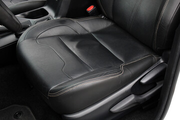 Obraz premium Driver seat of a lux car. Leather car interior. Black leather drivers seat in a car. Front seats of a modern business class sedan car. 