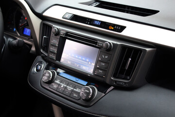 Screen multimedia system on dashboard in modern car. Panel of modern car. Close-up of an electronic dashboard in a modern car. Lux car dashboard with multimedia touch screen. SUV control panel.