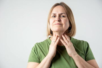 Woman thyroid gland control. Mature lady sweeping the laryngeal, laryngitis, goiter or Hypothyroidism. Disorder of the endocrine system. Hashimoto’s Thyroiditis, Lymphocytic Thyroiditis.	