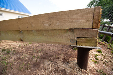 Wooden frame house foundation on screw piles