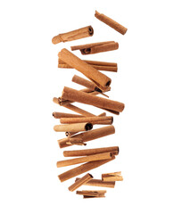Levitation of dry cinnamon sticks in the air isolated on a white background