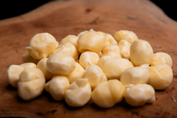 white cheese balls, on a wooden board