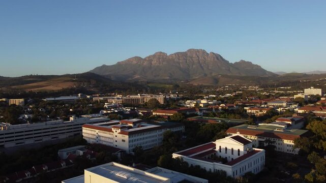 Evening aerial drone panorama above Stellenbosch, south Africa with a view towards the Simonsberg and hottentots mountain. Beautiful evening view
