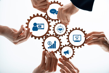 This image showcases hands interacting with gears that symbolize essential elements in digital marketing, illustrating growth, engagement, and strategic communication in business. Amity
