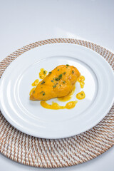 homemade chicken recipe with carrot sauce and couscous on white background