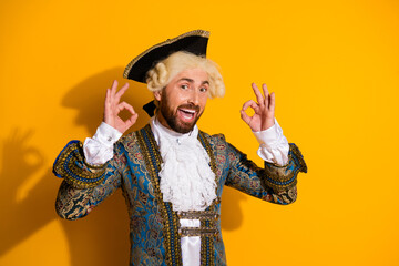 Portrait of young male in historic nobleman costume against yellow background combining vintage...