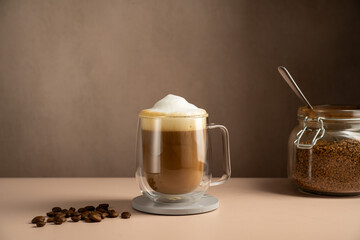 Coffee latte glass cup mug with milk foam and instant coffee