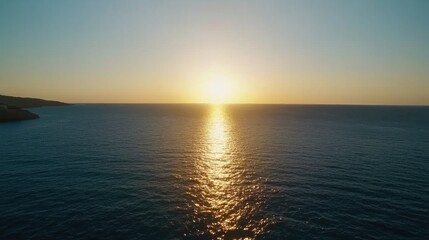 Obraz premium Serene Sunset Over Calm Ocean Waters