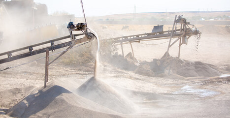 Vibrating screen stone crusher in operation. Crushing stones in a quarry for processing minerals,...