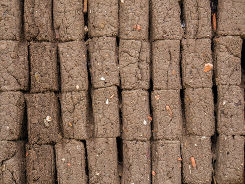 Close-up view of a section of a poorly build adobe bricks wall, in a house in the colonial town of Villa de Leyva, in central Colombia.