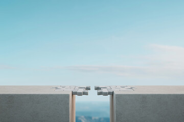 Puzzle pieces almost connecting on a cliff edge under a clear blue sky