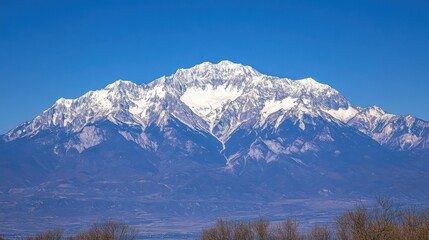 Majestic Snow-Capped Mountain Under Clear Blue Sky in Landscape