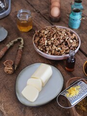 A vintage nutcracker works on natural walnuts in a rustic kitchen filled with farm-fresh ingredients, showcasing a cozy and traditional cooking atmosphere