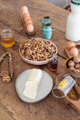 In a rustic kitchen, a vintage nutcracker opens walnuts on a weathered countertop, surrounded by fresh ingredients, creating a warm and cozy cooking atmosphere