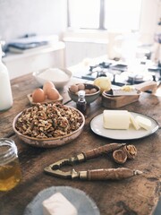 In a cozy farmhouse kitchen, a vintage nutcracker skillfully cracks open natural walnuts. Fresh...