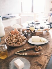 In a cozy farmhouse kitchen, a vintage nutcracker splits natural walnuts on a weathered wooden...
