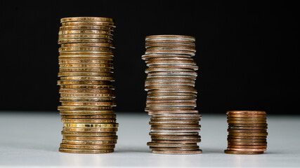 Stacks of coins arranged by size showcasing different denominations