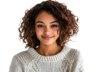 Smiling young girl with curly hair wearing a cozy sweater