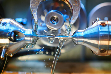 Precision manufacturing showcases intricate clockwork gears in a milling machine during lubrication...