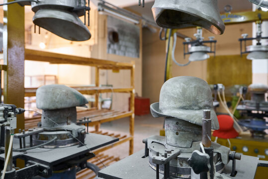 Crafting beautiful felt hats in a charming workshop filled with unique molds and artisanal tools that showcase the art of hat making