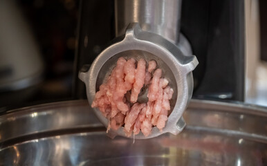 Electric meat grinder. Kitchen tool to mince meat. Meat grinding, preparing food ingredients....