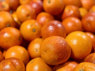 Box with ripe fresh organic tangerines on the shelf of a fruit supermarket are displayed for sale