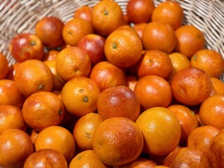 Box with ripe fresh organic tangerines on the shelf of a fruit supermarket are displayed for sale
