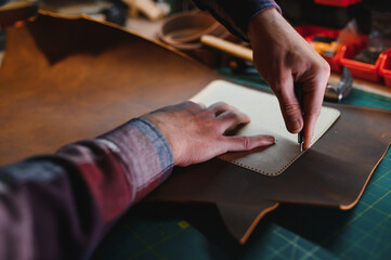 work in leather shop on dark background