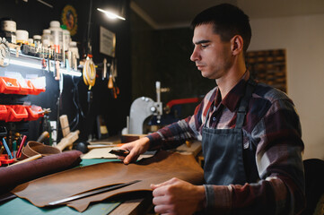 Banner tailor industry craftsman. Leather rolls and tools for handmade craft in workshop