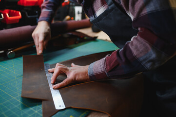 Banner tailor industry craftsman. Leather rolls and tools for handmade craft in workshop