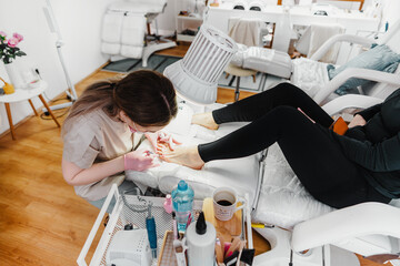 Professional podiatrist or chiropodist working. Foot and toenails beauty and hygienic treatments.