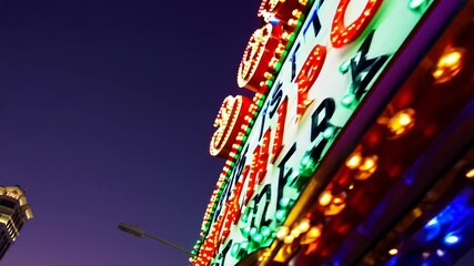 Vibrant lights illuminate Las Vegas Strip at twilight with iconic landmarks in view