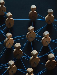 A group of wooden figures connected by blue wires, ideal for illustrations and presentations about technology or innovation