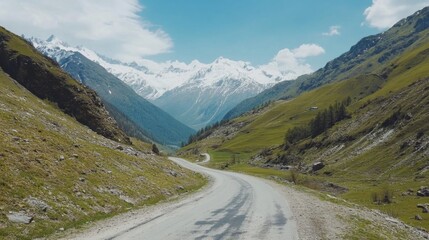 Serene Mountain Road Winding Through Lush Green Valley Landscape