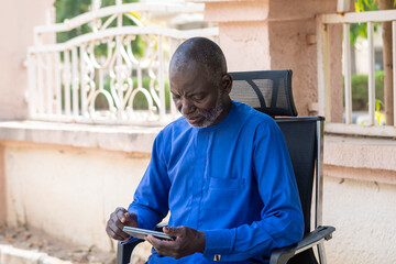 Portrait of a senior african man using smartphone