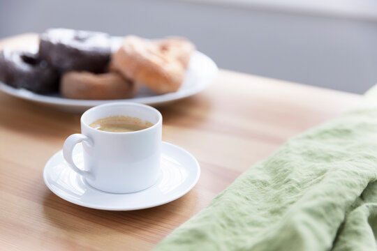 White Mug of Espresso on wooden table.