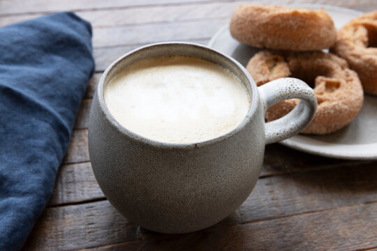 Cup of Coffee and Donuts on a Breakfast Table
