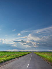 Fototapeta premium Long road with a clear blue sky above it