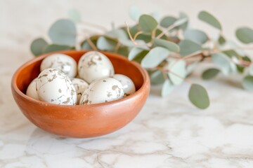 Elegant minimalist Easter centerpiece featuring marbled Easter eggs with eucalyptus leaves on a marble countertop