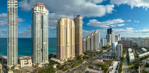 Fototapeta premium Expensive highrise hotels and condos on Atlantic ocean shore in Sunny Isles Beach city. American tourism infrastructure in southern Florida