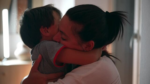 Mother hugging son tightly, eyes closed in warmth and affection, showing deep emotional bond and love in a tender family moment