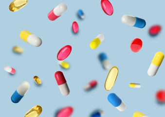 Many different pills flying on light blue background