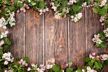 Spring flower arrangement, still life with blossoming apple tree branches on wooden background with space for text.Holiday card and spring greeting,screen banner,nature background