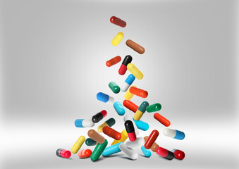 Many different pills falling on grey background